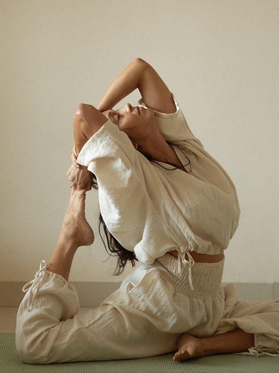 Shambhavi in a seated backbend, eyes closed